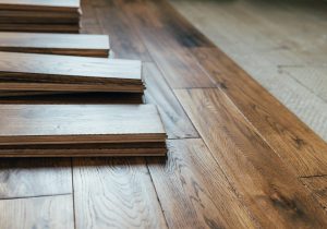 The process of house renovation with changing of the floor from carpets to solid oak wood. Beautiful golden handscraped oiled European oak brushed for added texture and fine definition of wood grain